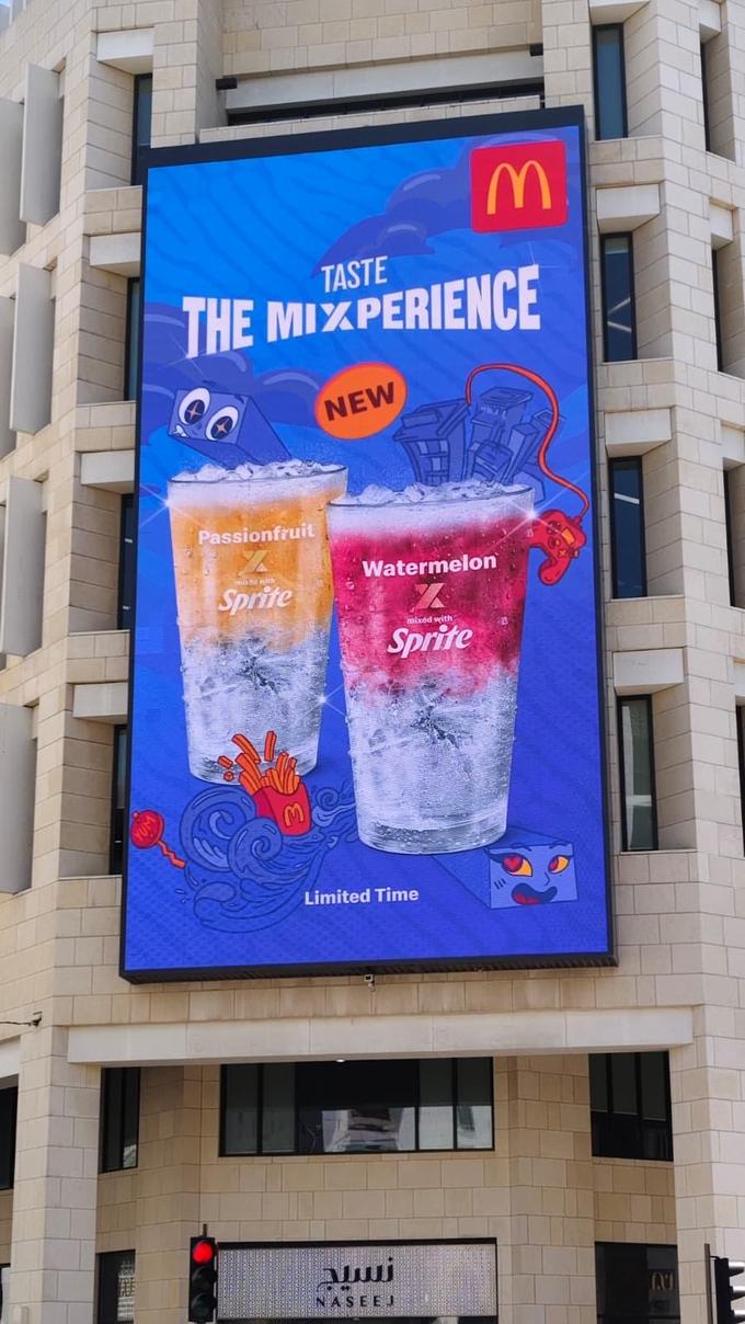 Live weather-reactive DOOH for McDonald's Qatar: temperature-driven Sprite billboard in Doha